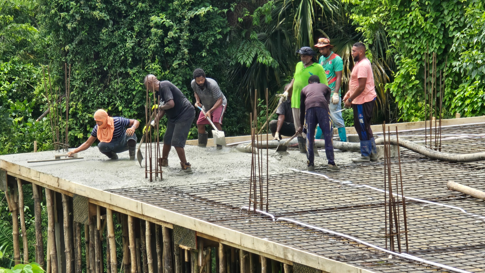 Workers placing concrete on the new church facility